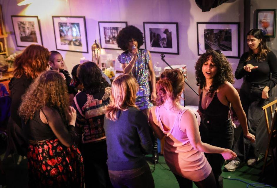 A group of people dancing in front of a singer