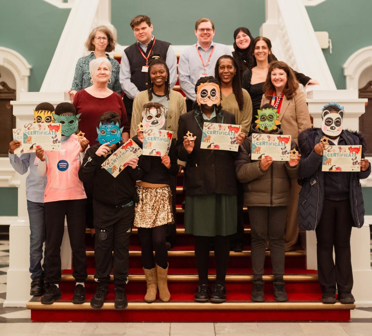 group of children holding certificates, councillors, members of Creating Ground, guest panel speakers and council staff.