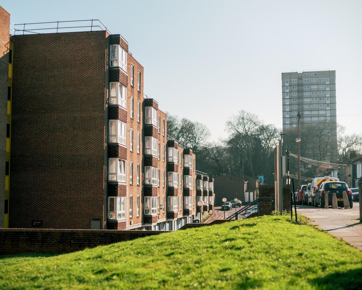a council block with a high-rise residential building in the background