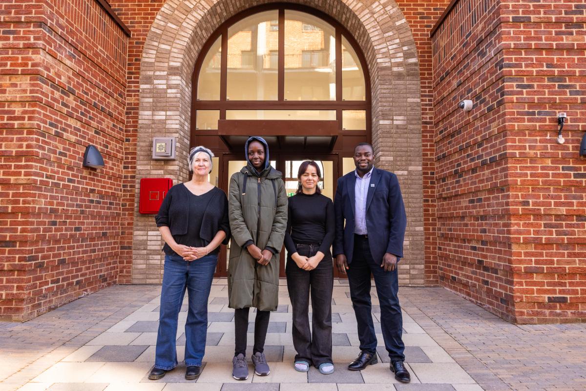 A photo of Councillors Anthony Okereke and Pat Slattery with two tenants outside new council homes at Kidbrooke Park Road