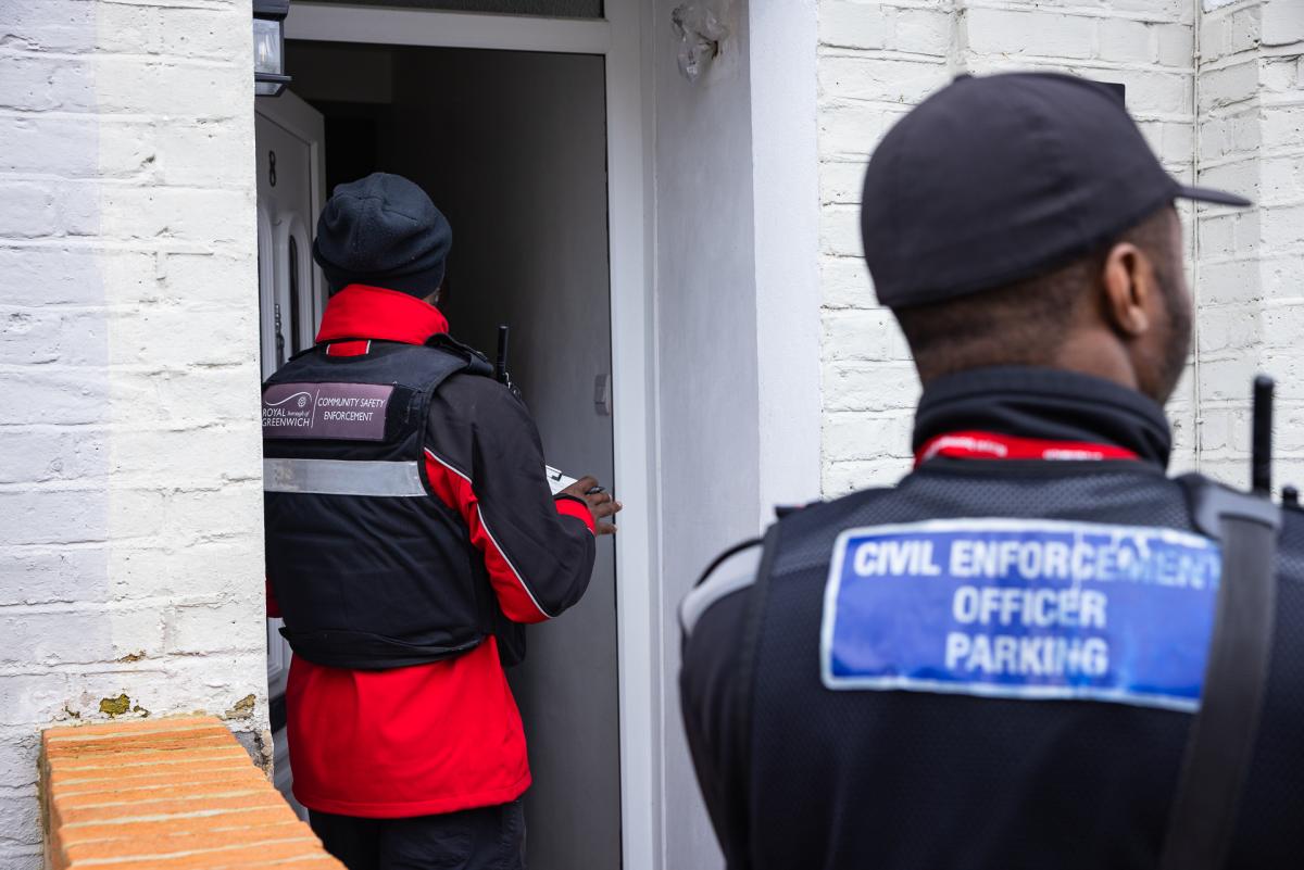 A Community Safety Enforcement Officer and a Parking Officer knock at a door