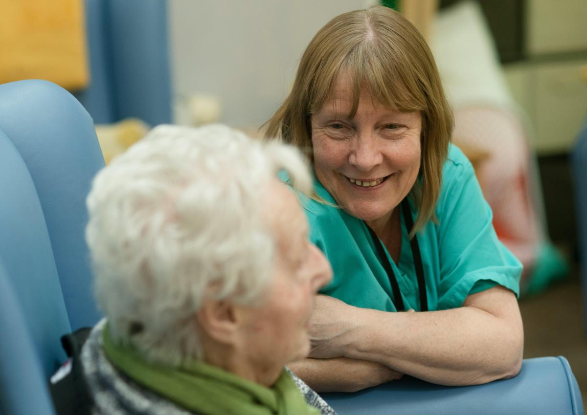 Care worker smiling at elderly woman
