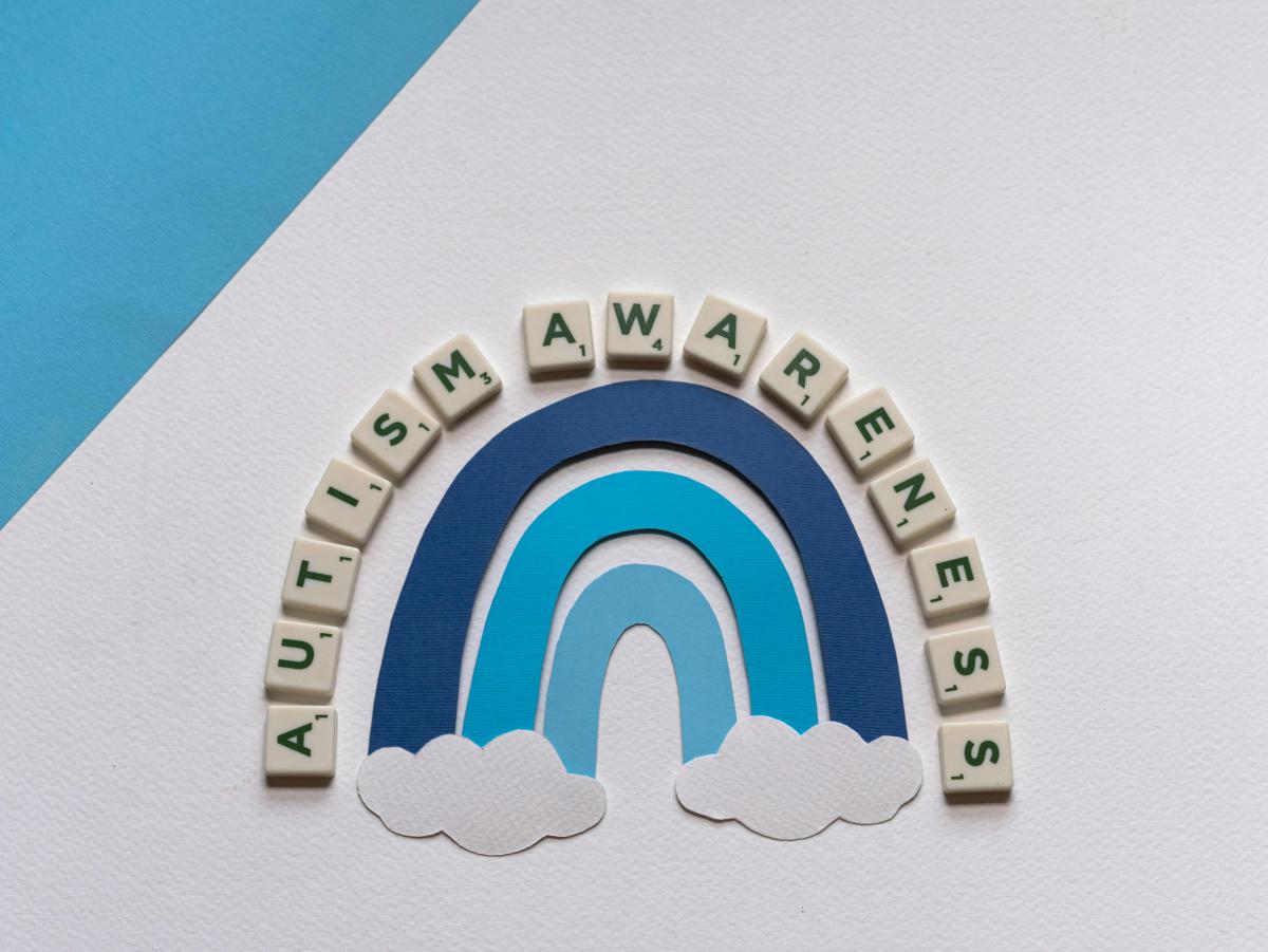 a blue rainbow with the words autism awareness