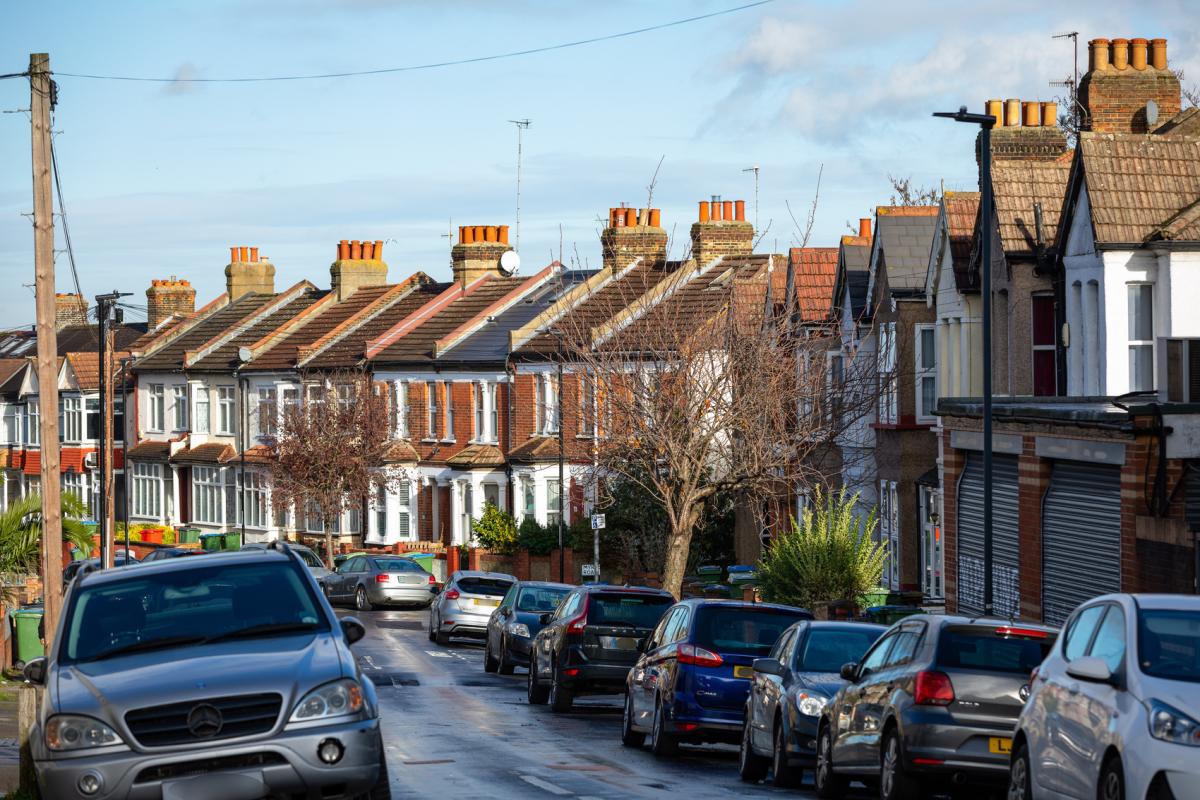Terraced housing with parked cars down either side
