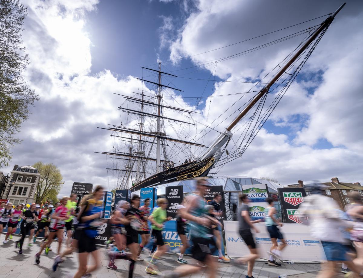 The Cutty Sark in the sun on marathon day, with runners blurred out in the foreground