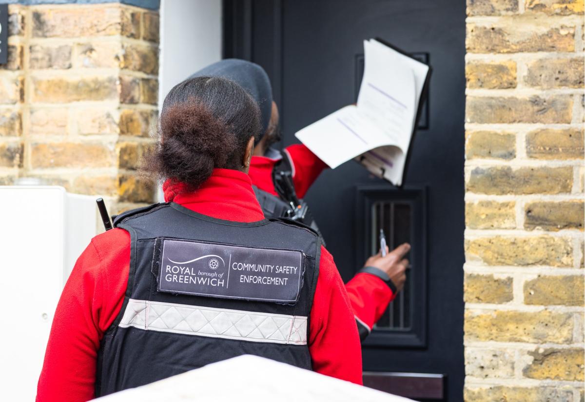 Two Community Safety Enforcement Officers knocking on a door.
