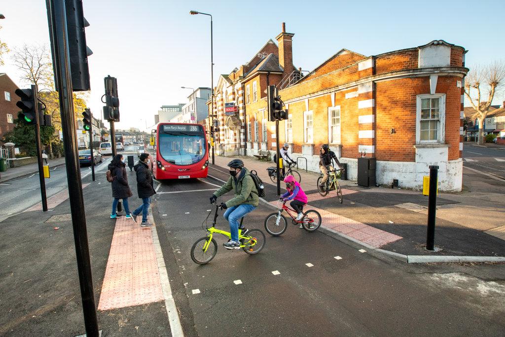 Two cyclists crossing the road.