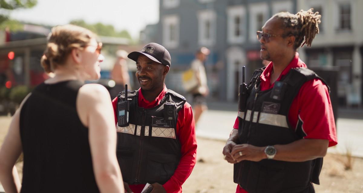 Two Community Safety Enforcement Officers speak to a resident.