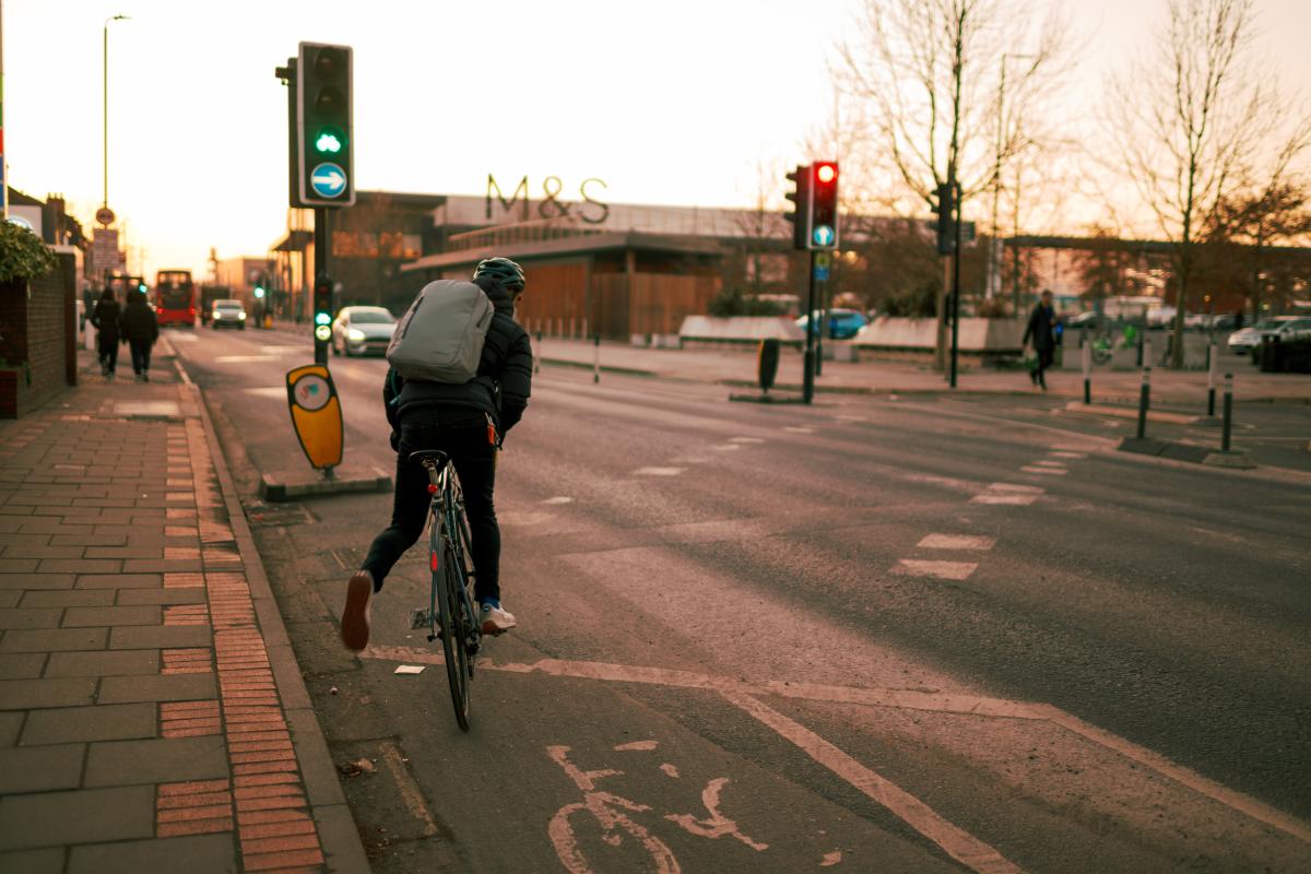 person on bike using signal crossing for cycles