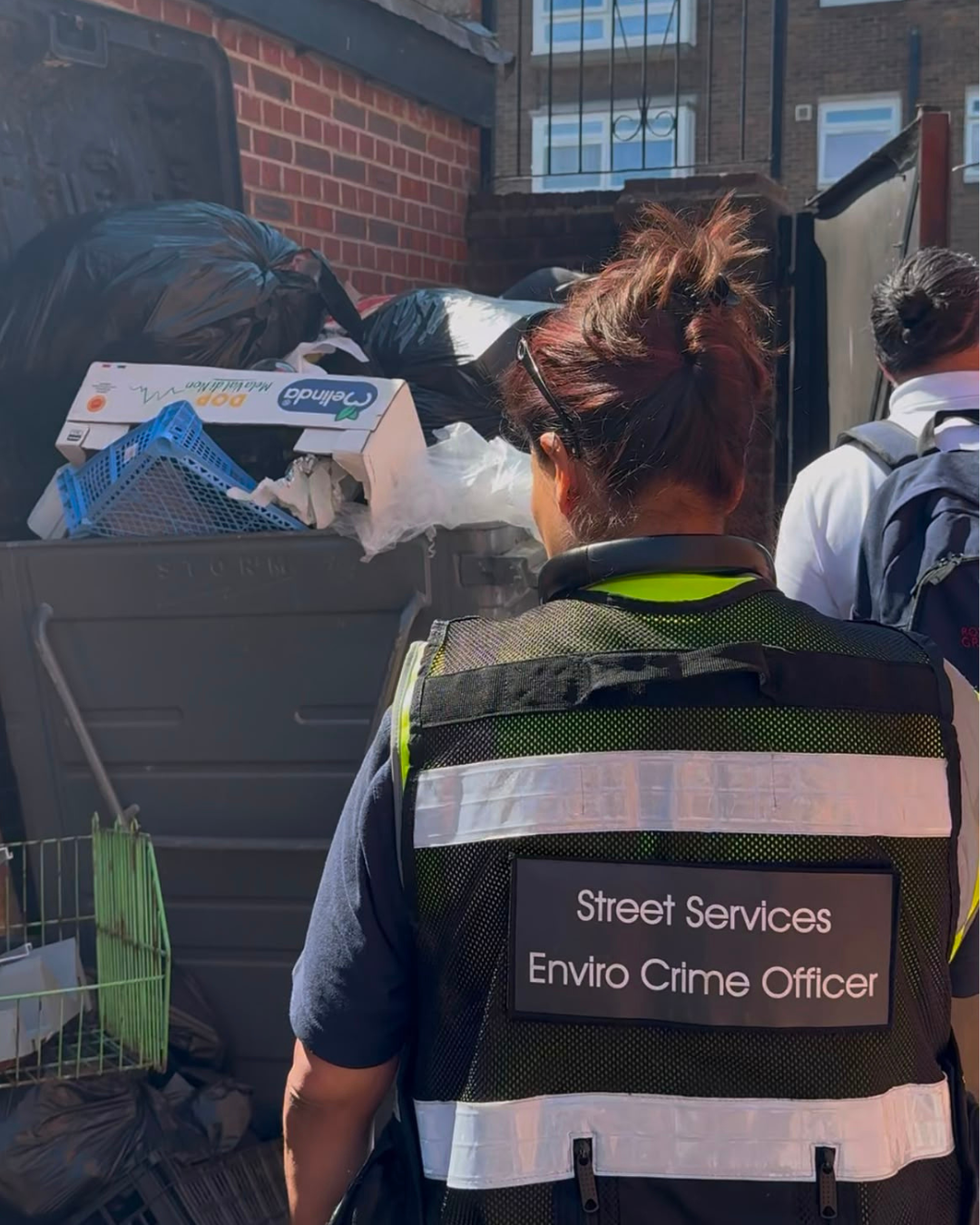 Enforcement officer in high-vis vest reading "Street Services Enviro Crime Officer"