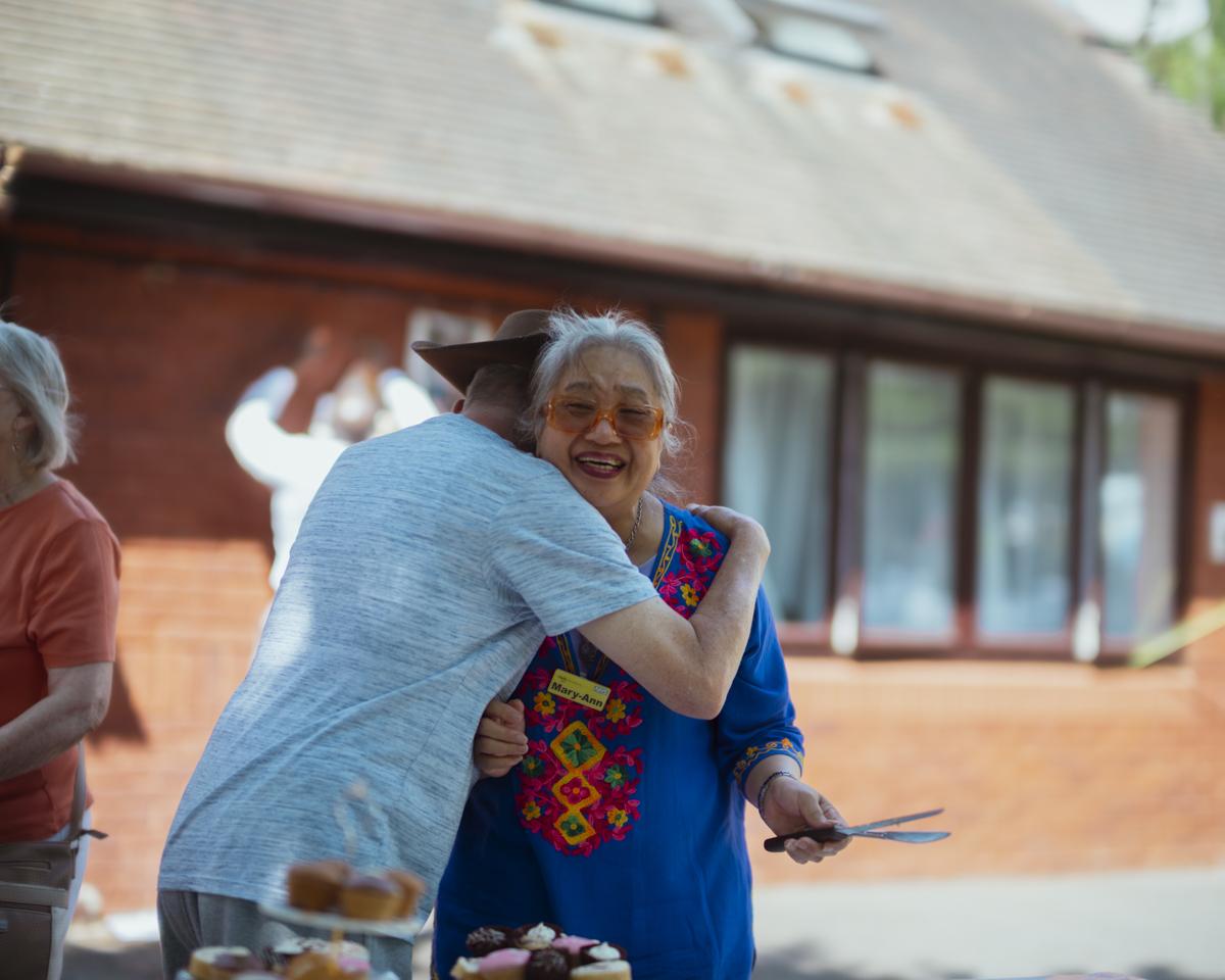 Image of two residents hugging
