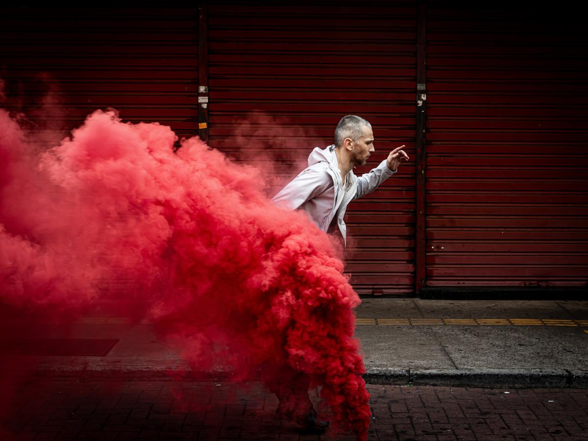 A person running through red smoke