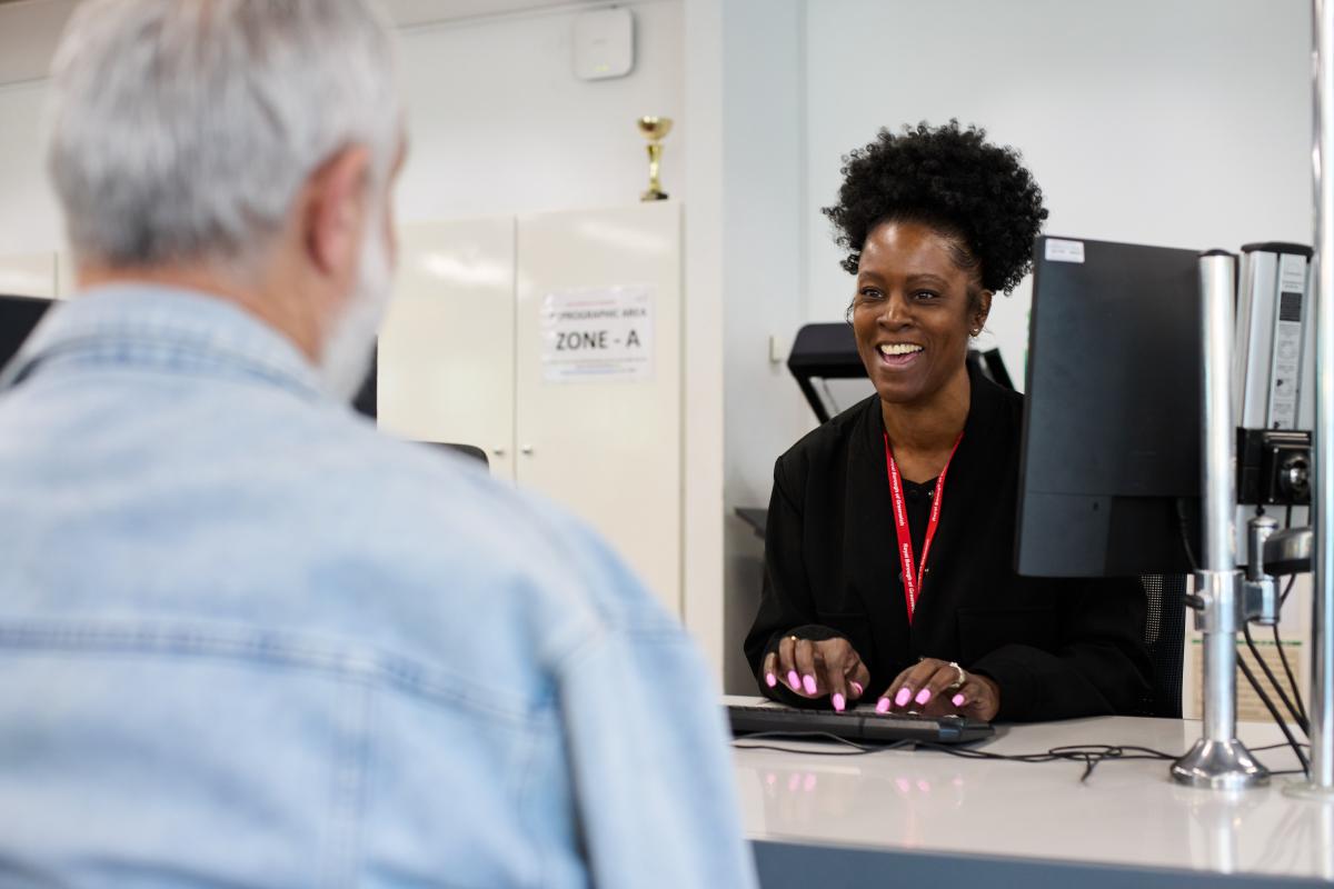 Greenwich Supports pilot officer supporting a resident, she is smiling at the resident shown with their back is to camera
