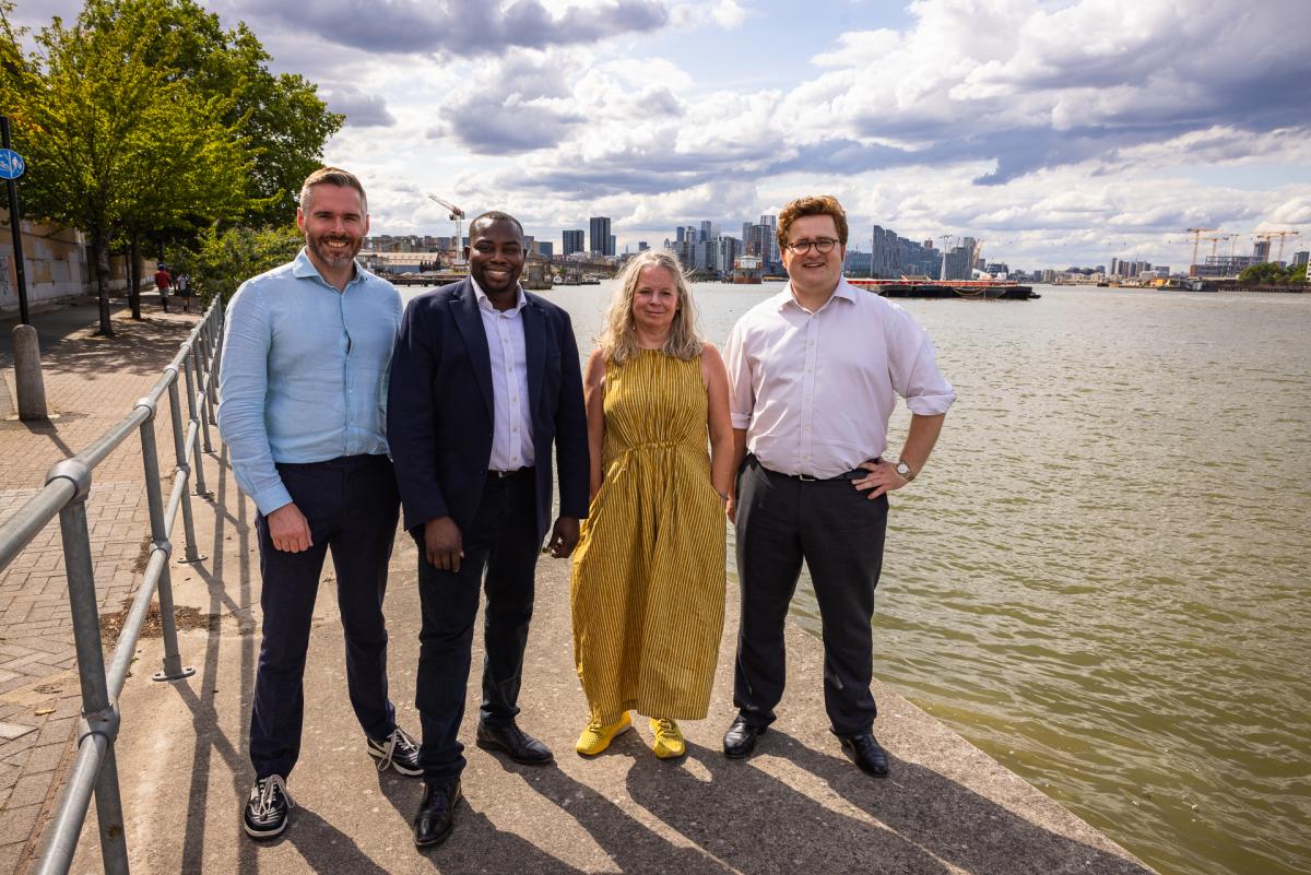 An image of people in front of the River Thames next to the Charlton Riverside site