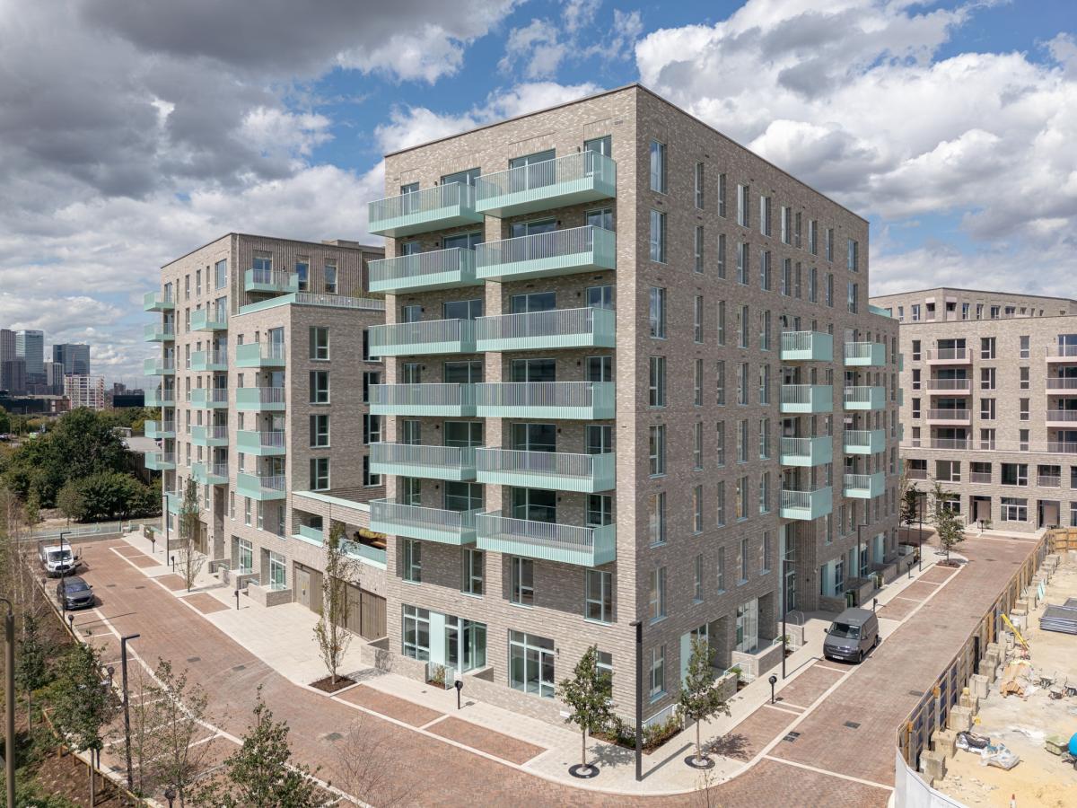 A photograph of a modern eight storey block of council homes at Greenwich Millennium Village.