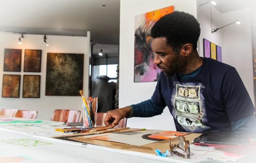 An artist sat at a table drawing