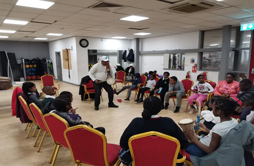 A group of children enjoying a drumming workshop.