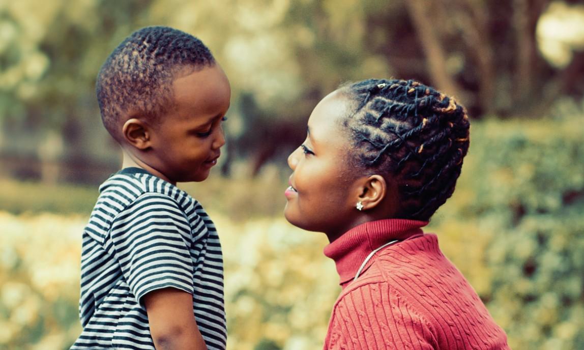 A foster parent speaking fondly to her son.