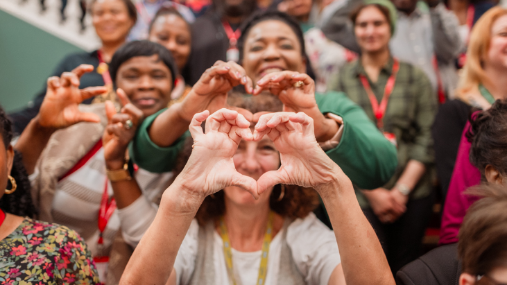 A group of Greenwich council employees smiling and making a heart shape with their hands