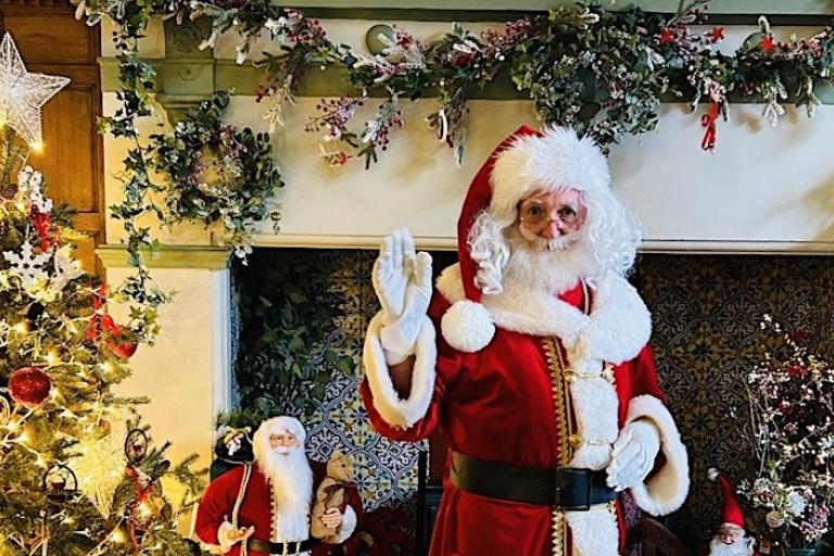 A man in a red suit with a white beard 