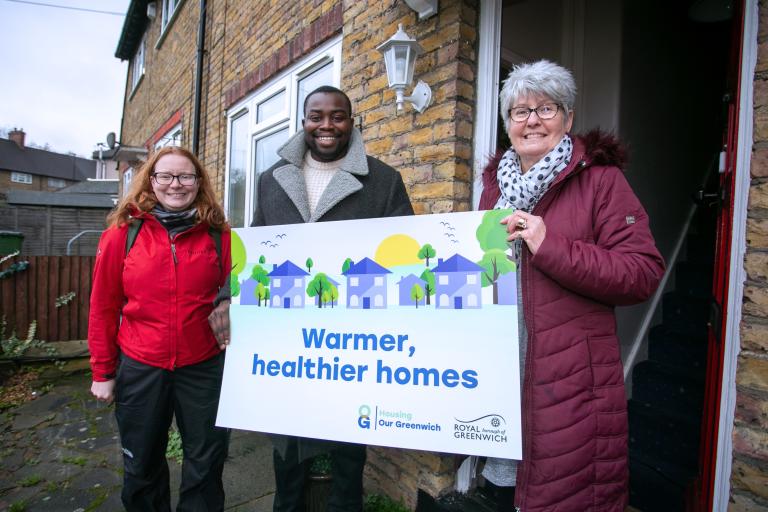 Cllr Taggart-Ryan, Leader Anthony Okereke and a resident in Horn Park holding a sign which says 'Warmer, healthier homes'