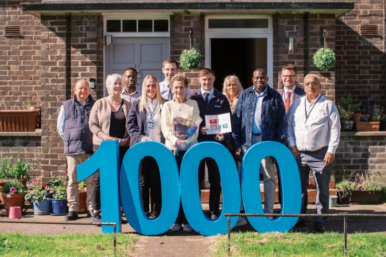 Group shot featuring Sheila Hassett (with flowers) Council Leader Anthony Okereke (3rd, right), Cllr Pat Slattery (2nd, left), staff from Mulalley and the RBG Repairs & Investment Team.