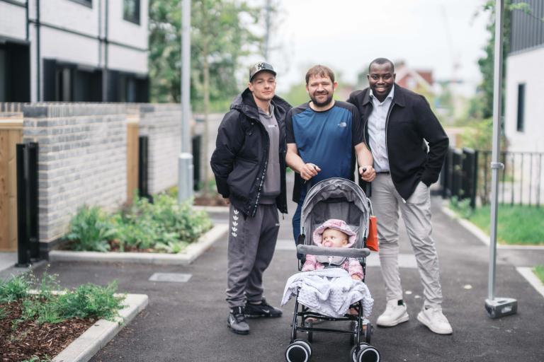 Photo of two tenants with Leader of the Council Cllr Anthony Okereke, Mayor of Greenwich outside new council homes