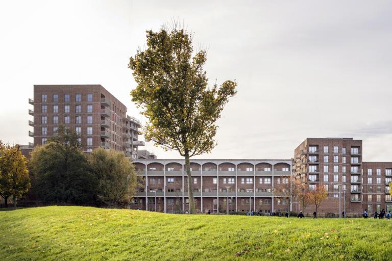 A photograph of the new 122-home development with greenery in the foreground