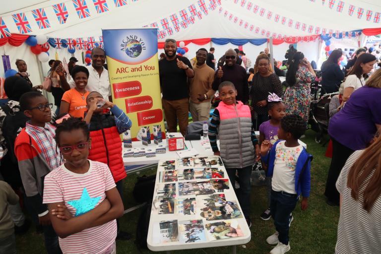 A group of people inside a marquee at an event.