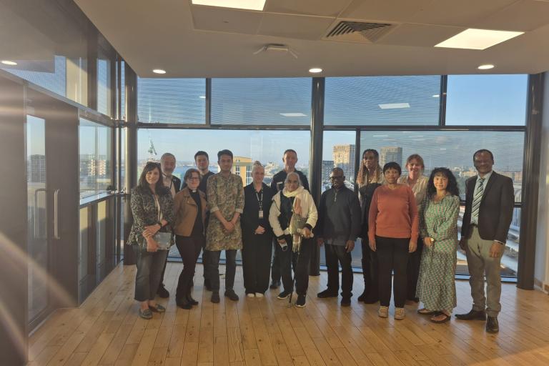 Attendees of the last Multifaith forum standing in a semicircle.