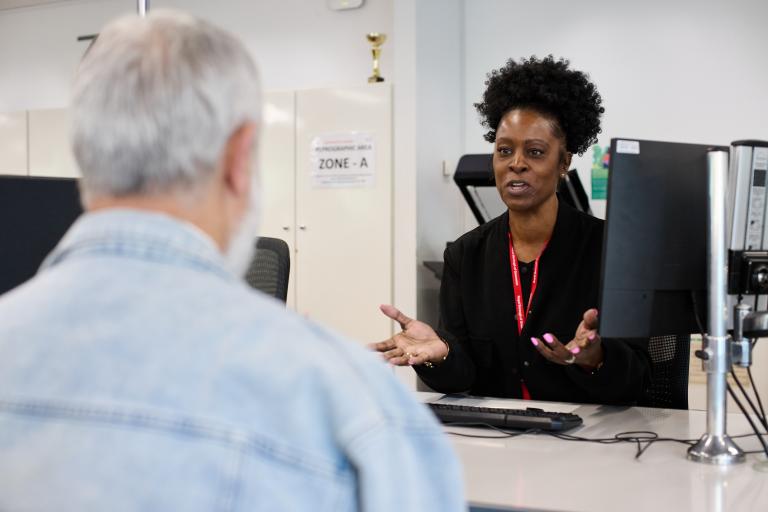 A council staff talking to a resident