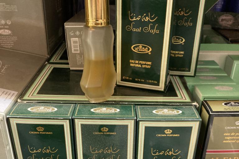Stacked boxes of perfume with a tester bottle on the top.