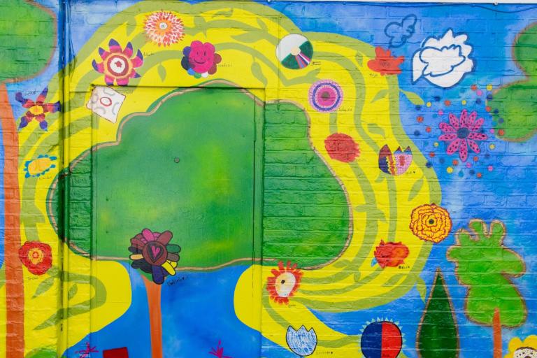 Colour painted mural of flowers and trees by artist Mural Haffeera Cader Saul and Nightingale Primary School