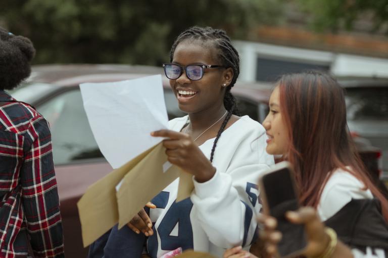 A girl opening her GCSE results in August 2025