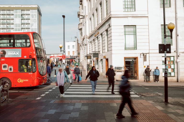 Zebra crossing in Woolwich Town Centre, bus and people crossing visible