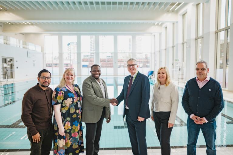 An image showing Council Leader Anthony Okereke hand Woolwich Waves over to GLL Chief Executive Peter Bundey