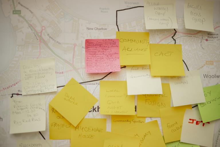 A map of Greenwich with multicoloured post-its that list ideas for community activities like quiz nights, a community garden, toy library and more.
