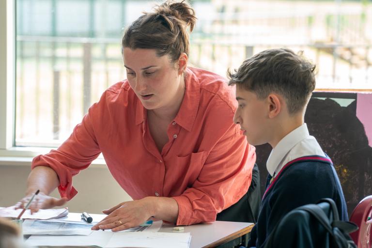 Female teacher supporting student in class