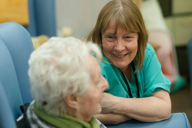 Care worker smiling at elderly woman