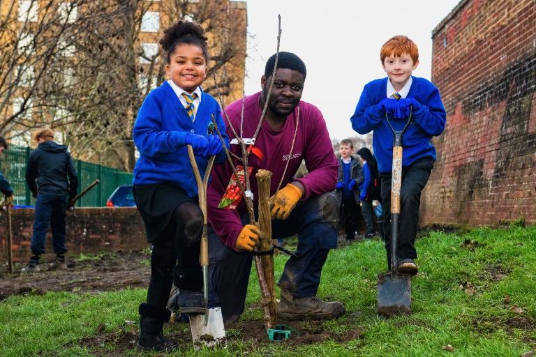 School children helping to plant new saplings in Abbey Wood