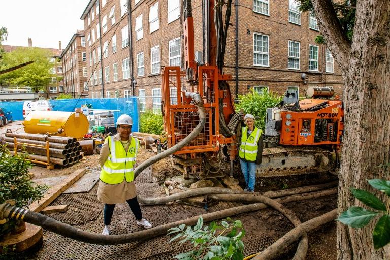 People in hi-vis vests next to a borehole and machinery at Ernest Dence Estate