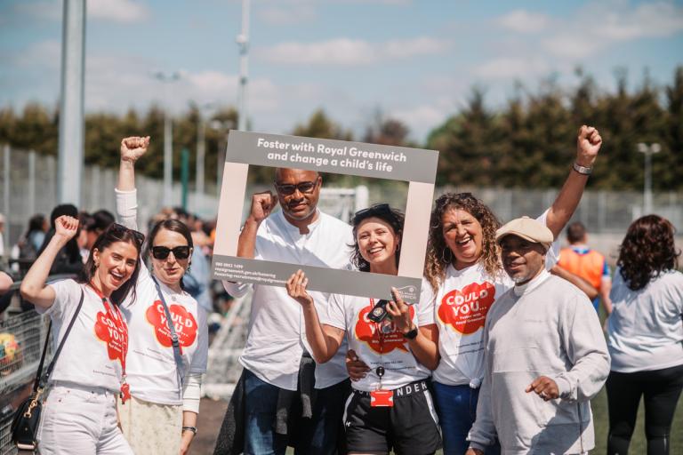Staff wearing 'could you foster' t-shirts, holding a frame that asks 'could you change a child's life'