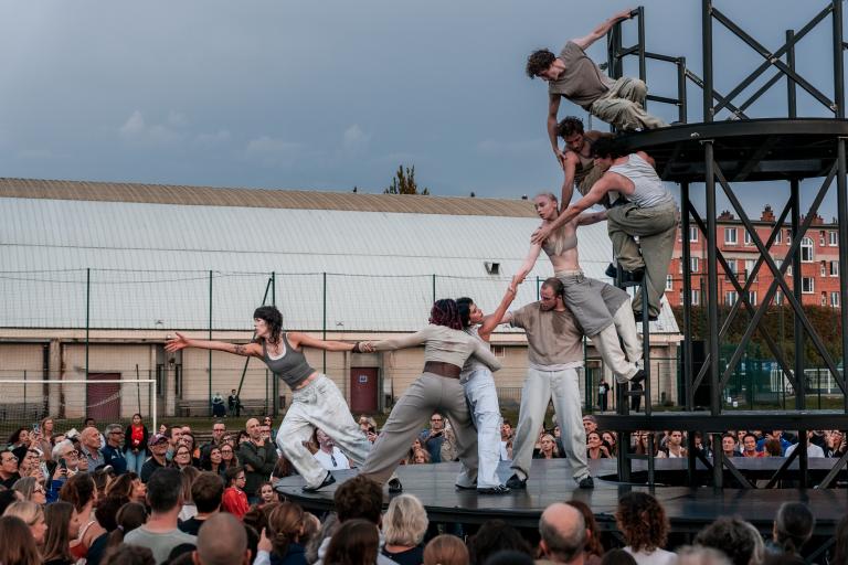 GDIF performance in 2025, performers climbing on a metal structure