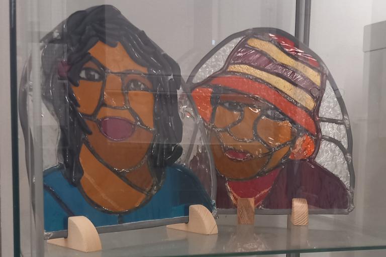 Two stained glass portraits on display