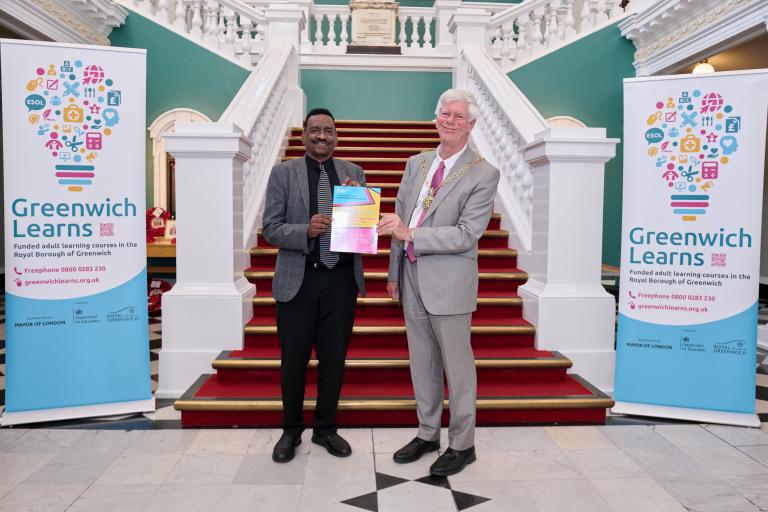 Abdelmonen holds his certificate with the Mayor, Cllr David Gardner