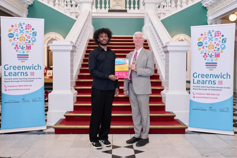 Mason holds up his certificate in the Town Hall with the Mayor, Cllr David Gardner
