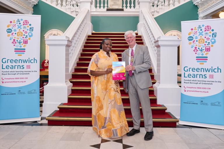 Urelles holds up her certificate with the Mayor, Cllr David Gardner at the Town Hall