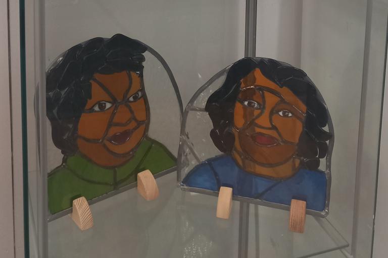 Two stained glass portraits on display