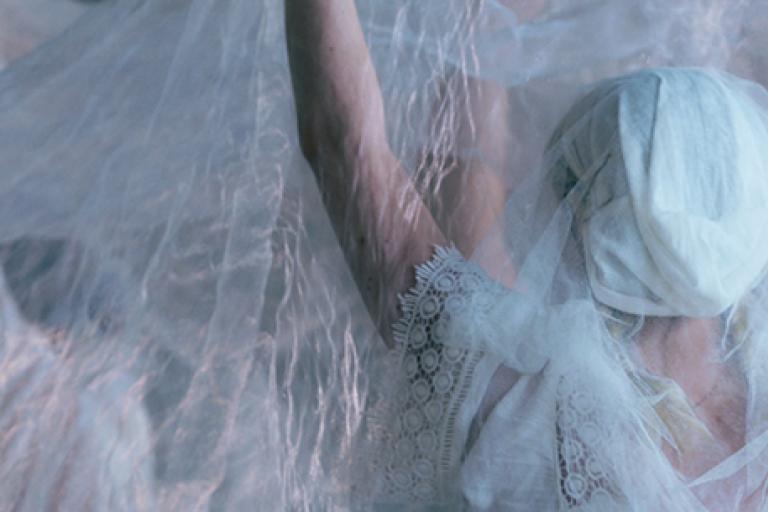 The back of a person wearing all white