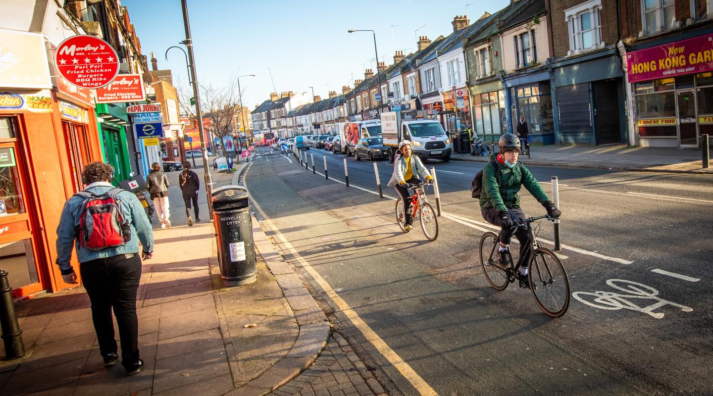 A picture showing a street in Greenwich which shows cyclists using the cycle lane
